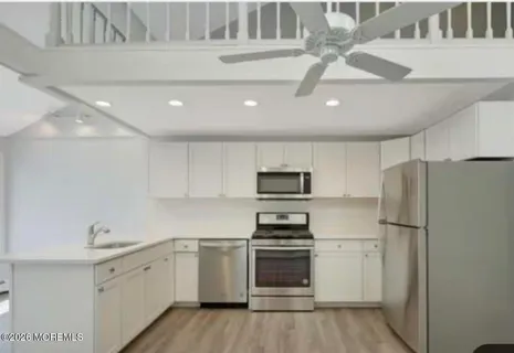 a kitchen with a refrigerator a sink and dishwasher