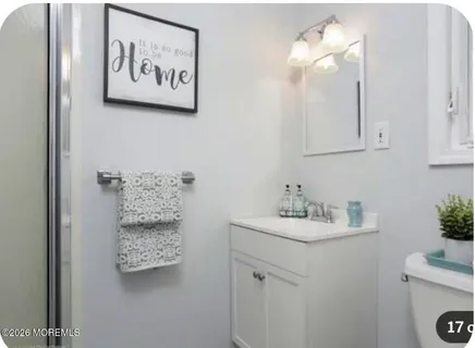 a bathroom with a sink mirror and vanity