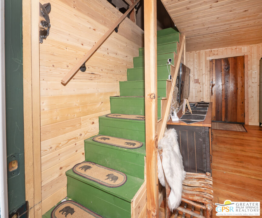 69 7 Oaks Road Angelus Oaks, CA 92305 - Photo 19 of 36 a view of a balcony with furniture and wooden floor