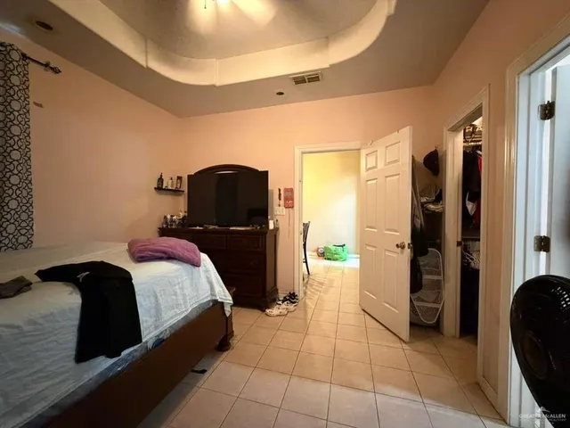 a bedroom with a bed and a mirror