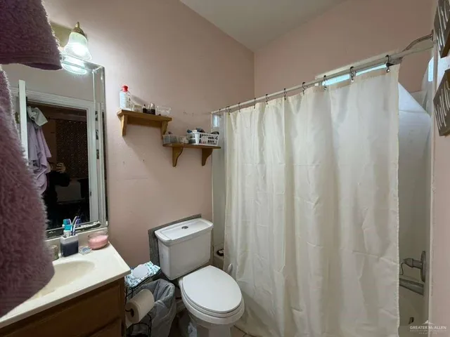 a white toilet sitting next to a bathroom sink