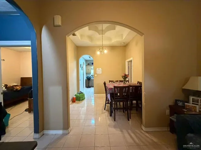 a view of a dining room with furniture and a chandelier