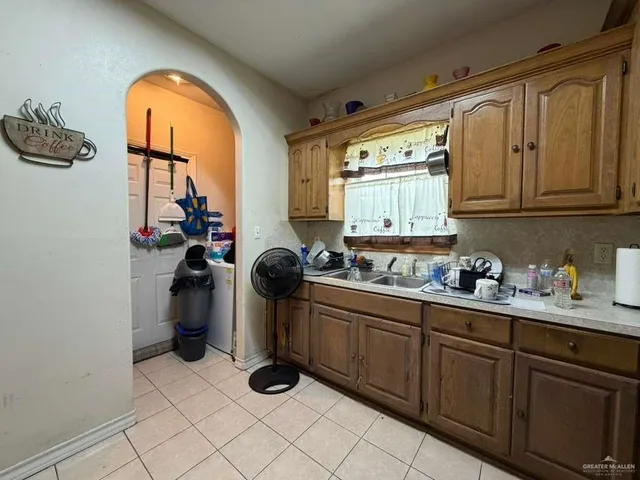 a kitchen with sink cabinets and window