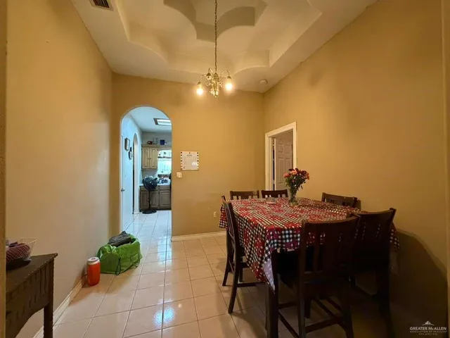 a view of a dining room with furniture and chandelier