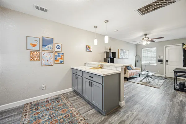 a kitchen with sink cabinets and wooden floor