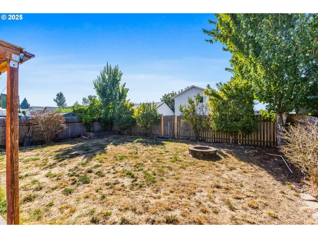 a backyard of a house with a yard and outdoor seating
