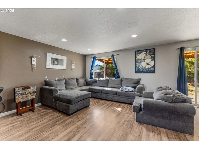 a view of a livingroom with furniture and a flat screen tv