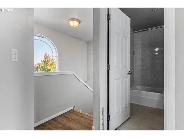 a view of bathroom with a window and a shower