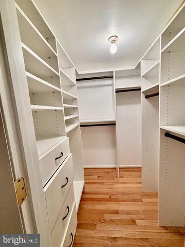 a view of walk in closet with empty racks