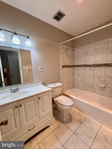 a bathroom with a sink a toilet and bathtub