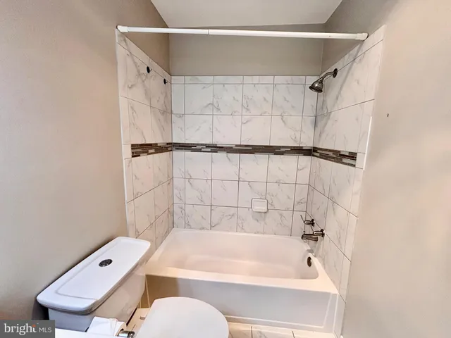 a bathroom with a shower curtain and a bathtub