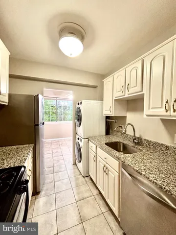 a kitchen with a stove a sink and a refrigerator