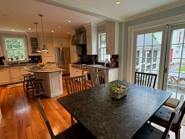 a dining room with furniture and wooden floor