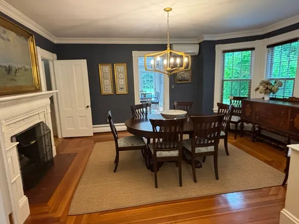 a view of a dining room with furniture window and wooden floor