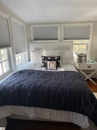 a bedroom with a bed and window