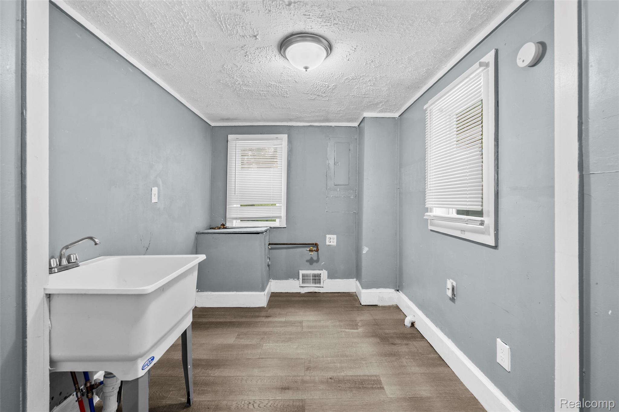 3605 Ash Street Inkster, MI 48141 - Photo 14 of 25 Laundry area with a textured ceiling and wood finished floors