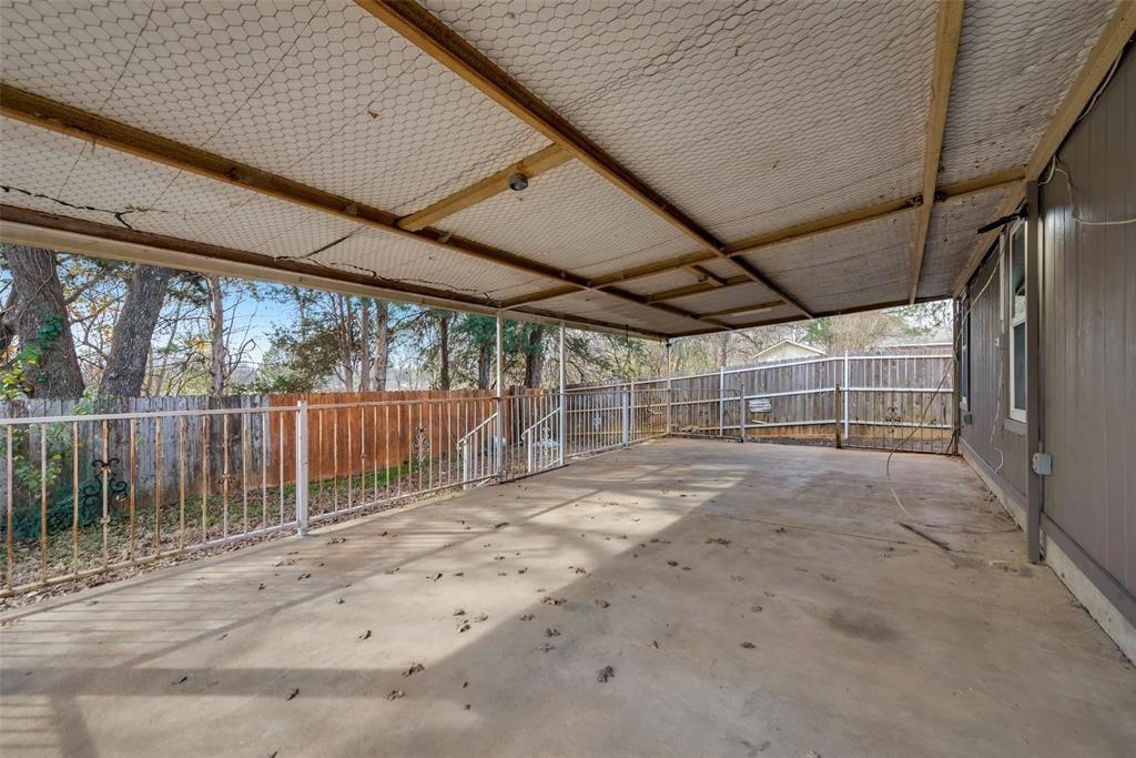 9227 Crimnson Court Dallas, TX 75217 - Photo 9 of 9 Fenced backyard featuring a patio and a carport