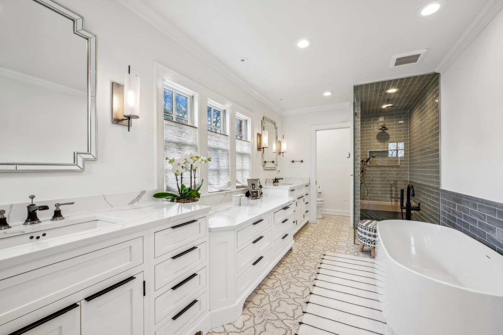 78 Robsart Road Kenilworth, IL 60043 - Photo 28 of 44 a spacious bathroom with a double vanity sink a mirror and a bathtub