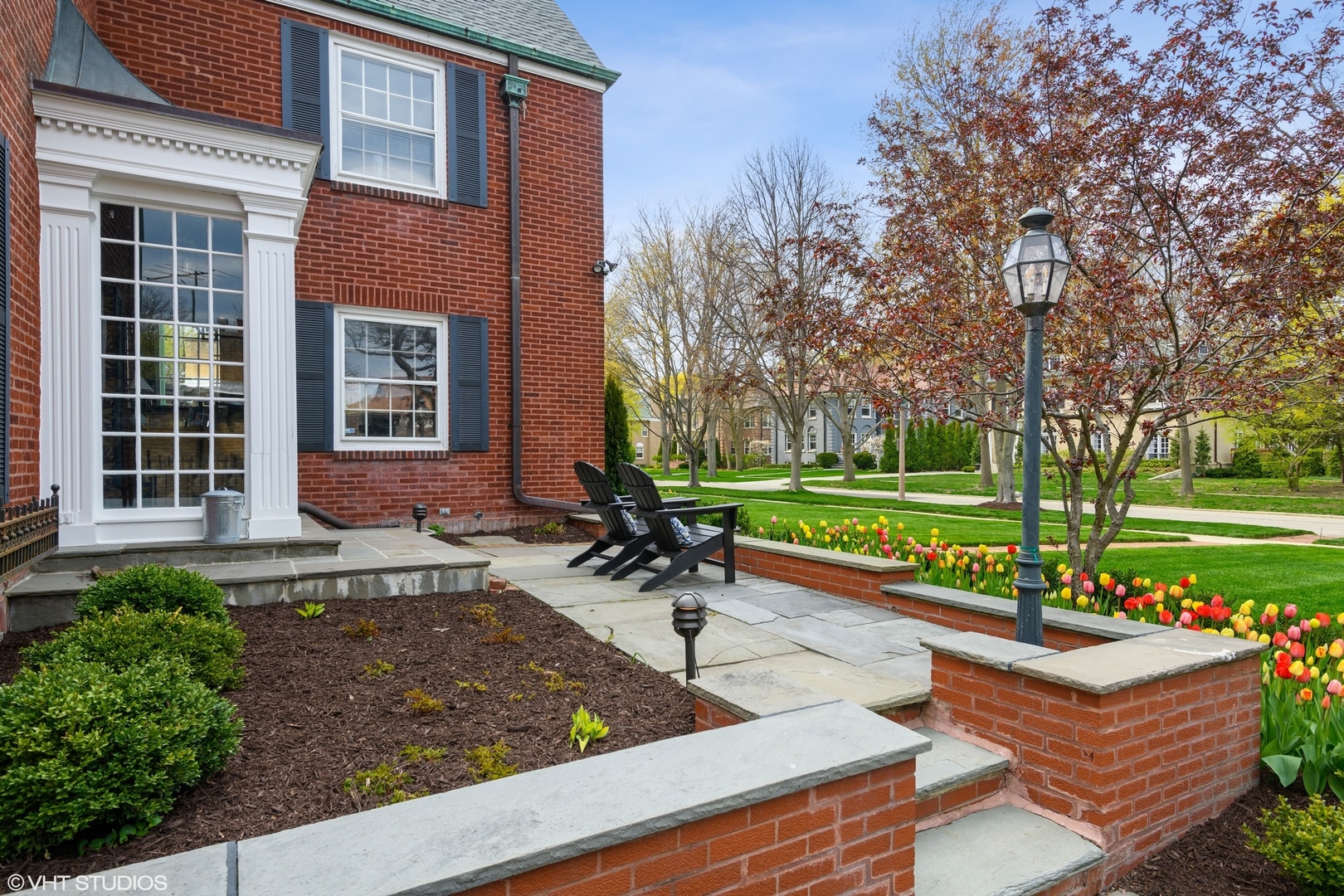 78 Robsart Road Kenilworth, IL 60043 - Photo 43 of 44 a front view of a house with a yard table and chairs