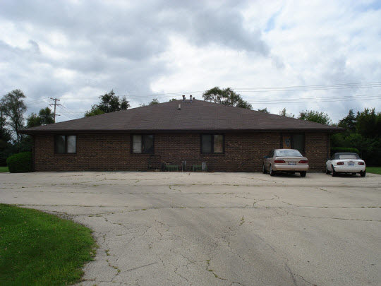 10042 Bitterroot Road Roscoe, IL 61073 - Photo 1 of 1 a front view of a house with a yard and garage
