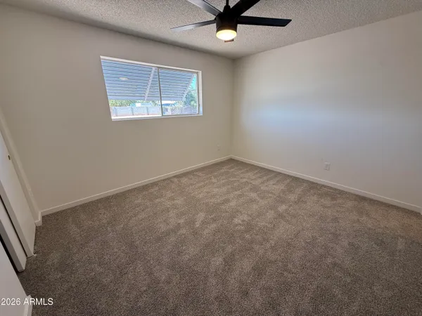 an empty room with closet and mirror