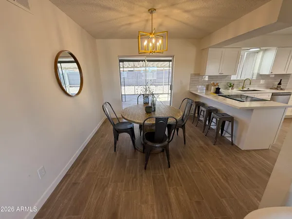 a kitchen with a sink cabinets and wooden floor