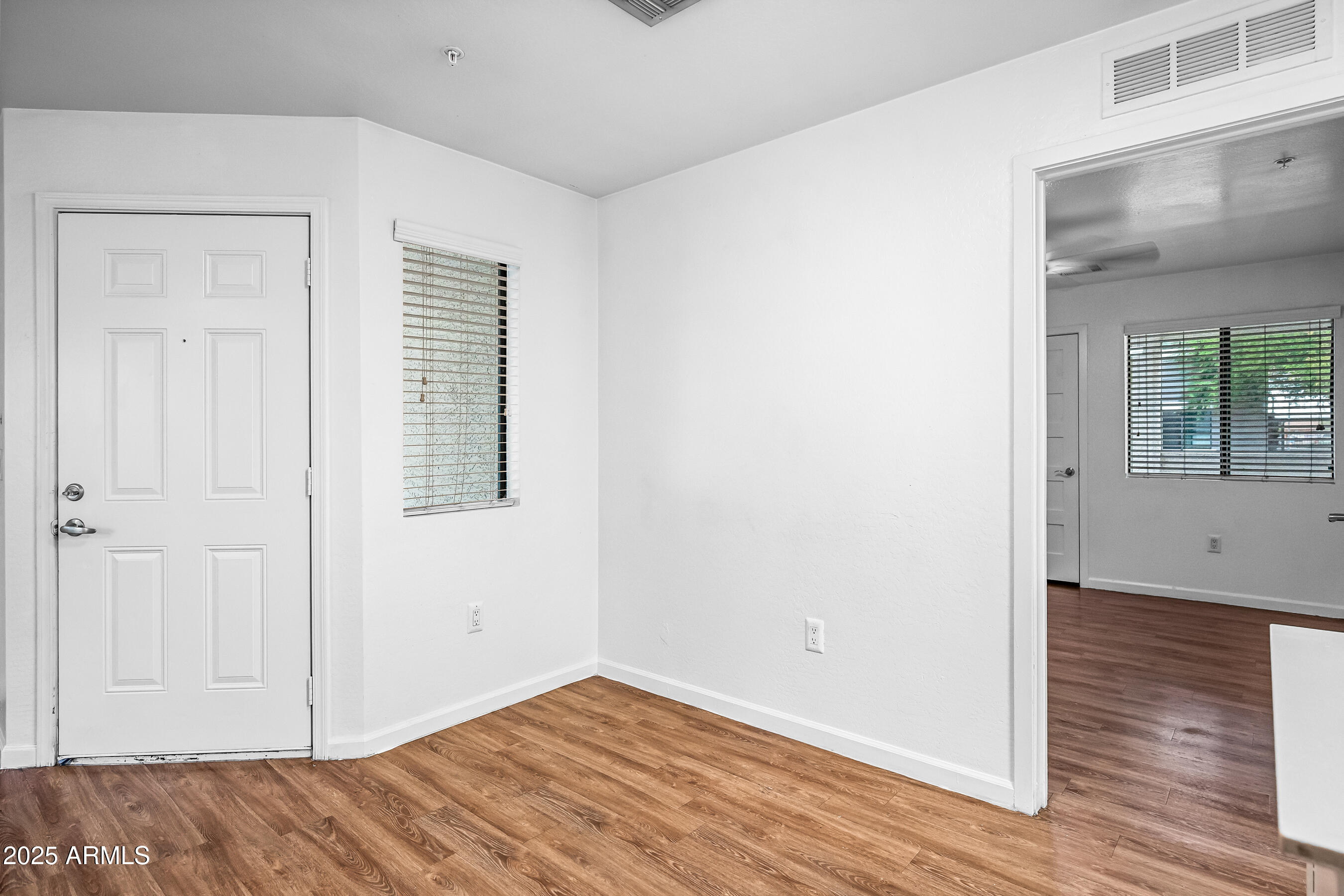 3065 North 67th Avenue, Unit 135 Phoenix, AZ 85033 - Photo 11 of 30 a view of an empty room with wooden floor and a window