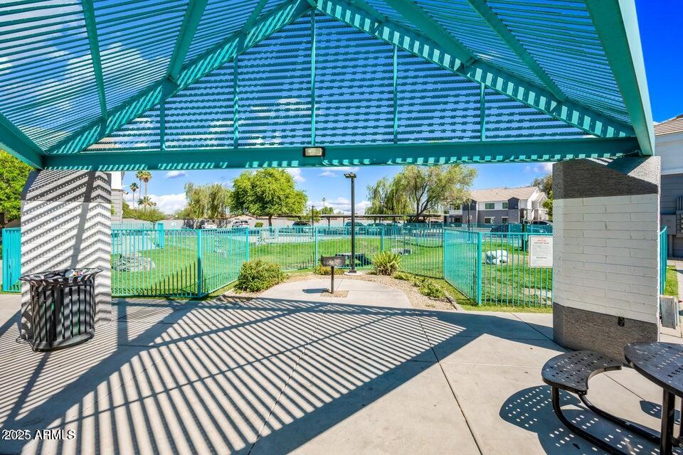 3065 North 67th Avenue, Unit 135 Phoenix, AZ 85033 - Photo 28 of 30 a view of a patio with a table and chairs