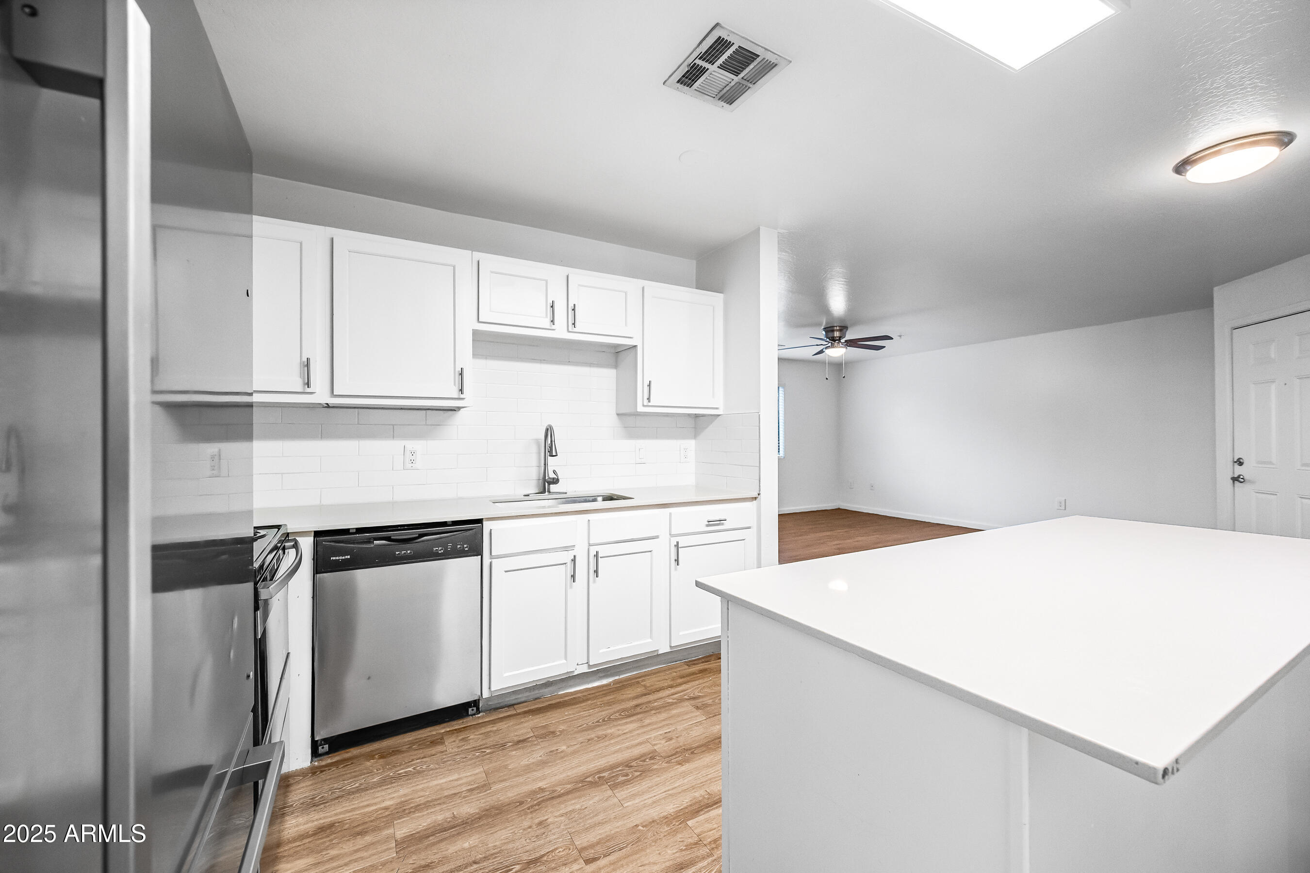 3065 North 67th Avenue, Unit 135 Phoenix, AZ 85033 - Photo 8 of 30 a kitchen with a sink a stove and cabinets