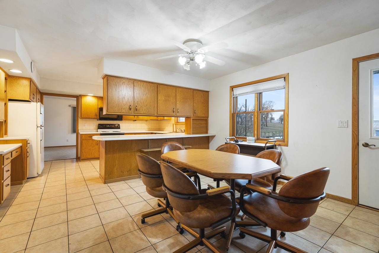 3178 North Berlin School Road Ridott, IL 61067 - Photo 11 of 47 a kitchen with stainless steel appliances kitchen island granite countertop a sink and cabinets