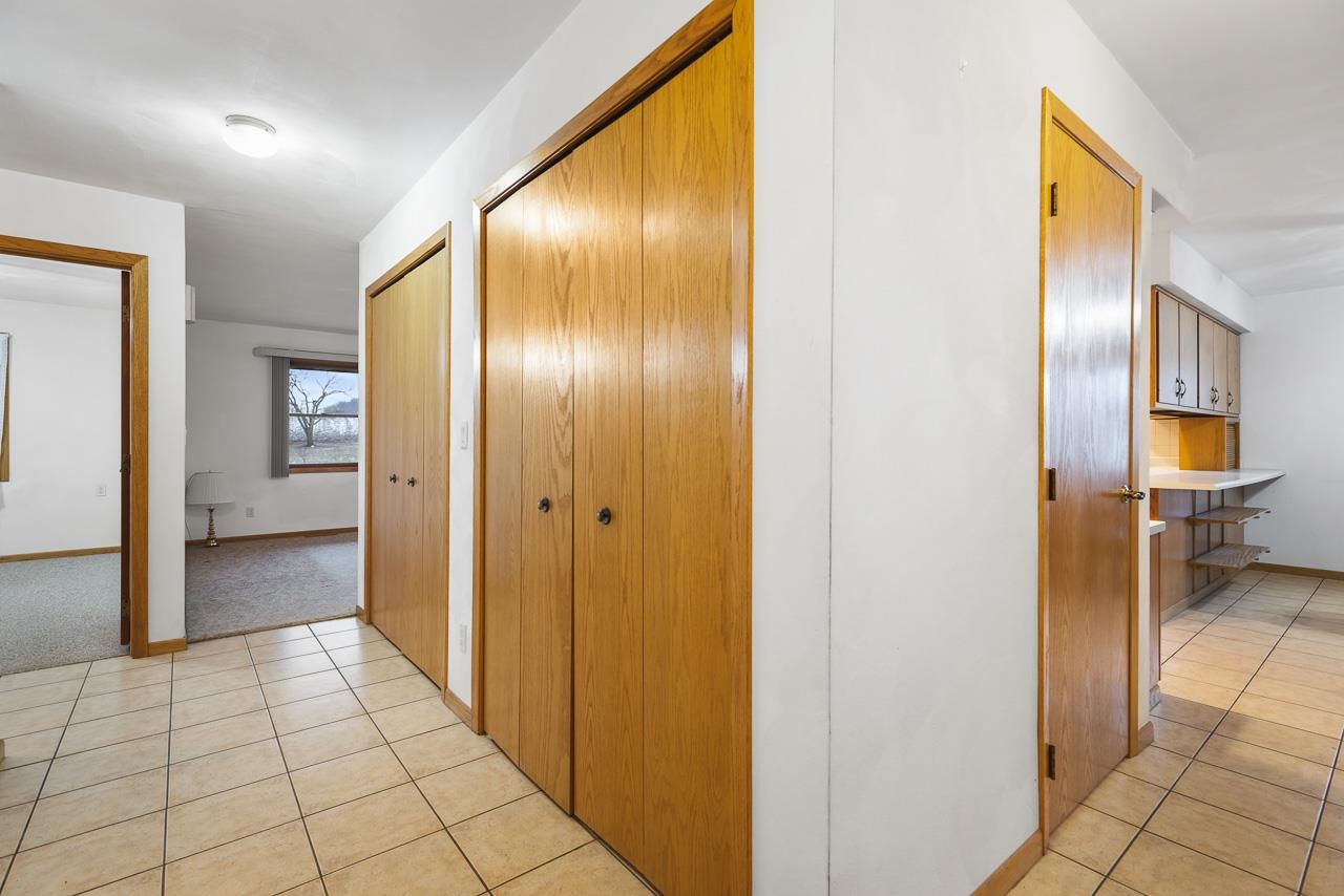 3178 North Berlin School Road Ridott, IL 61067 - Photo 13 of 47 a view of a hallway with wooden shelves