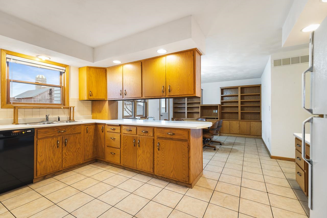 3178 North Berlin School Road Ridott, IL 61067 - Photo 16 of 47 a kitchen with stainless steel appliances a sink cabinets and wooden floor