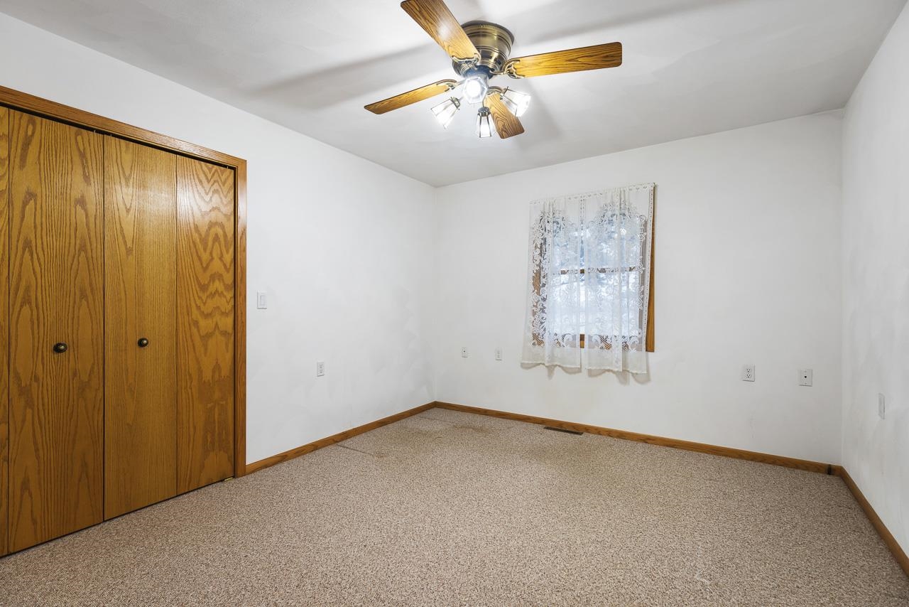 3178 North Berlin School Road Ridott, IL 61067 - Photo 20 of 47 an empty room with windows and fan