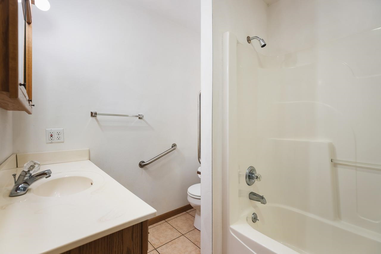 3178 North Berlin School Road Ridott, IL 61067 - Photo 21 of 47 a bathroom with a sink a toilet and shower