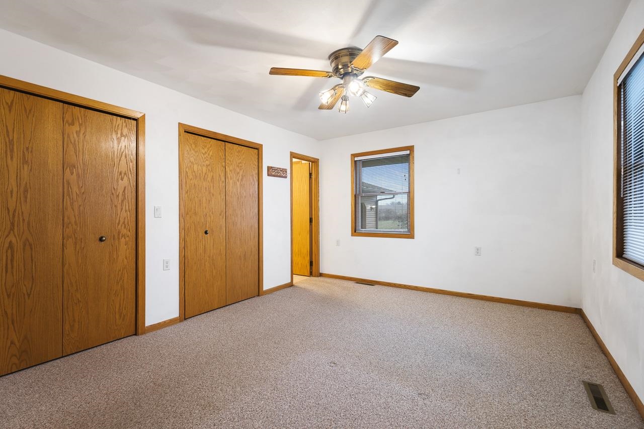 3178 North Berlin School Road Ridott, IL 61067 - Photo 22 of 47 a view of an empty room with chandelier fan