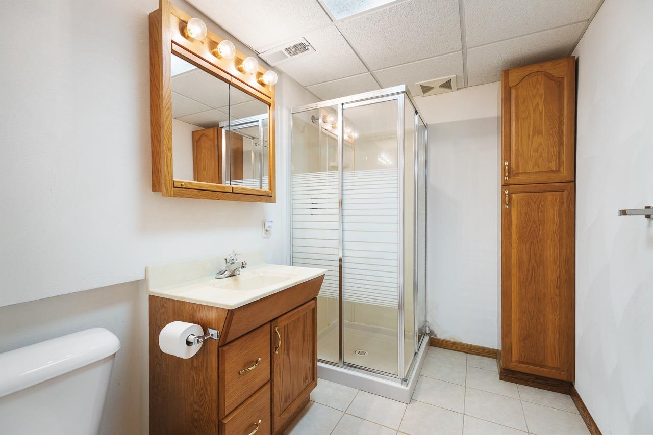3178 North Berlin School Road Ridott, IL 61067 - Photo 28 of 47 a bathroom with a sink a toilet and shower