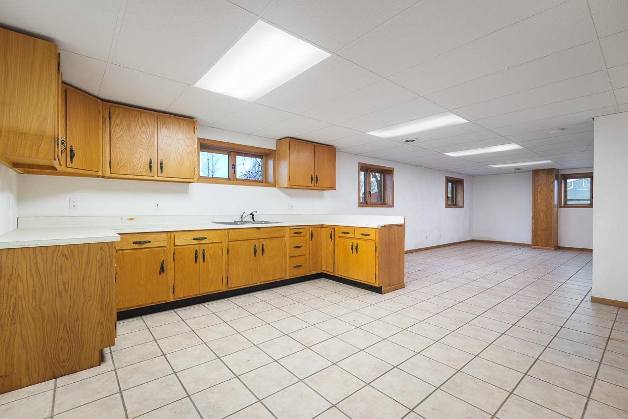 3178 North Berlin School Road Ridott, IL 61067 - Photo 29 of 47 a kitchen with granite countertop a sink and cabinets