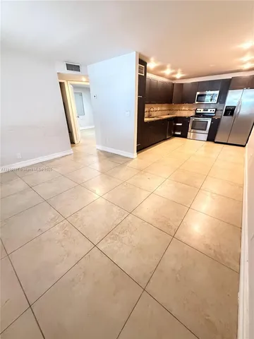 a very nice looking room with a gaming machine and cabinets