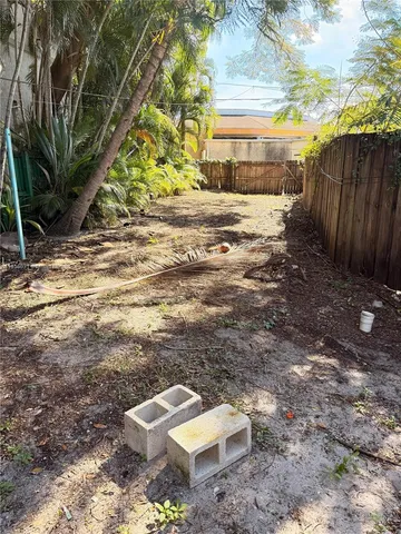 a backyard of a house with a yard and outdoor seating