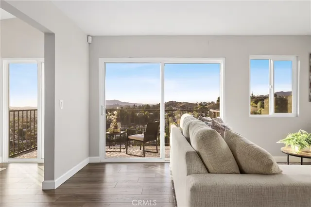 a living room with furniture and a floor to ceiling window