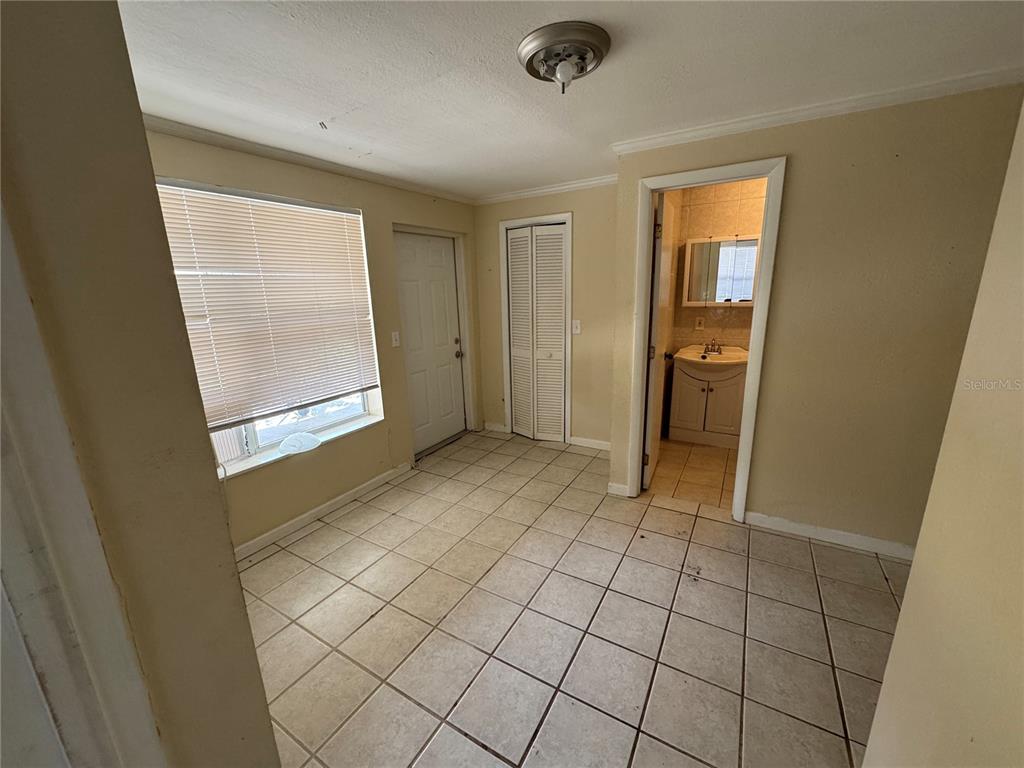104 Base Avenue West, Unit E Venice, FL 34285 - Photo 3 of 7 an empty room with mirror