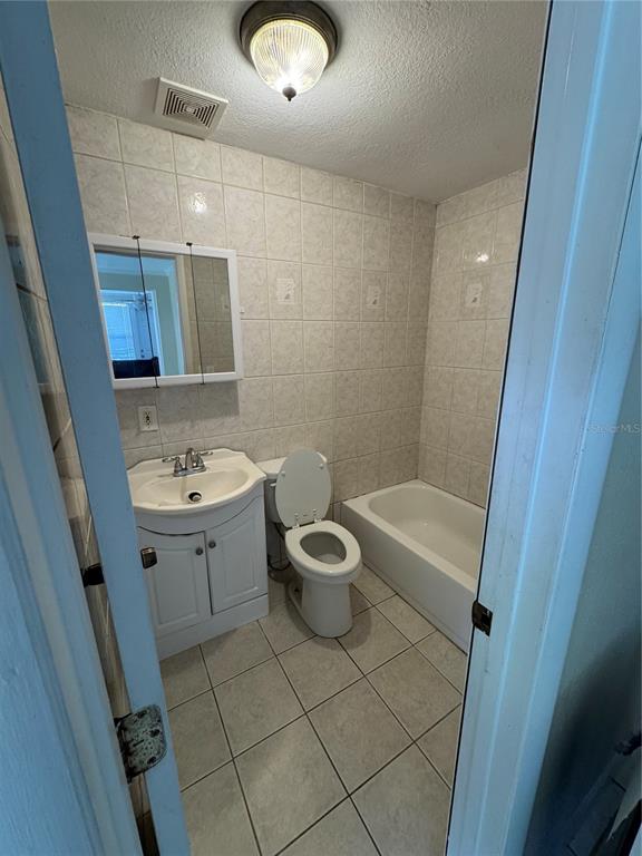 104 Base Avenue West, Unit E Venice, FL 34285 - Photo 4 of 7 a bathroom with a toilet sink and mirror