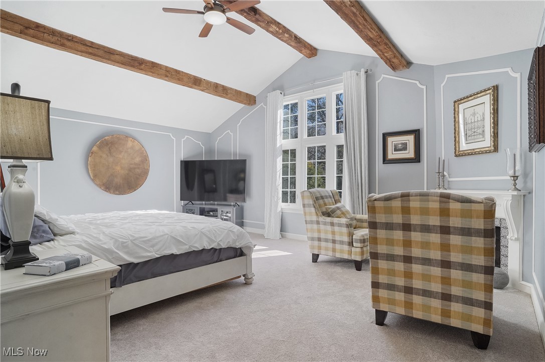 2070 Ridgewood Road Akron, OH 44313 - Photo 23 of 48 Bedroom featuring ceiling fan, carpet flooring, and vaulted ceiling with beams