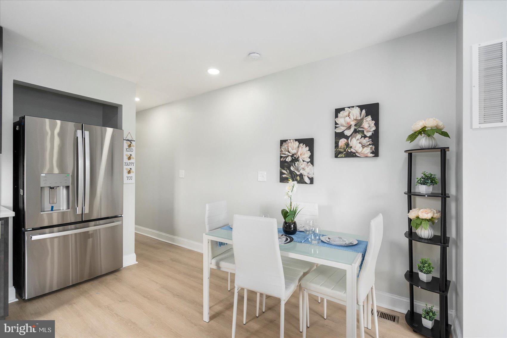 4002 Derby Manor Drive Baltimore, MD 21215 - Photo 13 of 32 a kitchen with granite countertop a refrigerator and a stove top oven