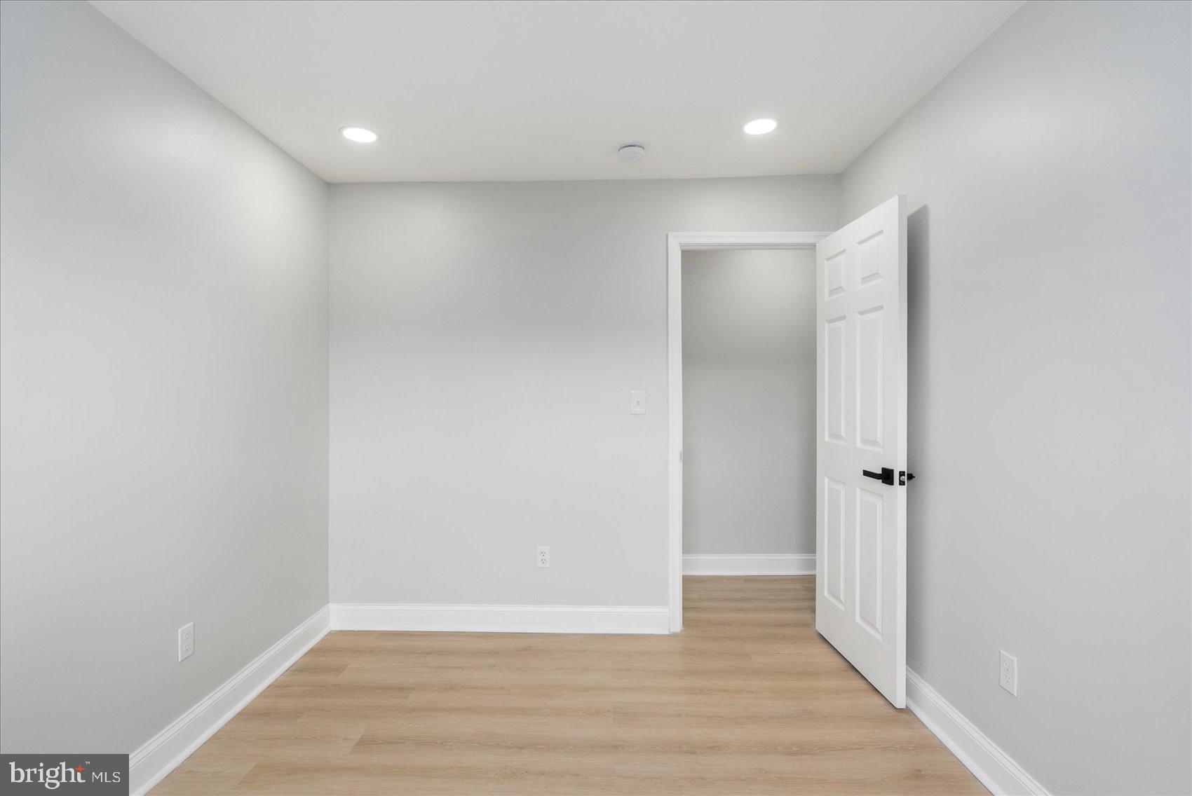 4002 Derby Manor Drive Baltimore, MD 21215 - Photo 15 of 32 a view of an empty room with wooden floor