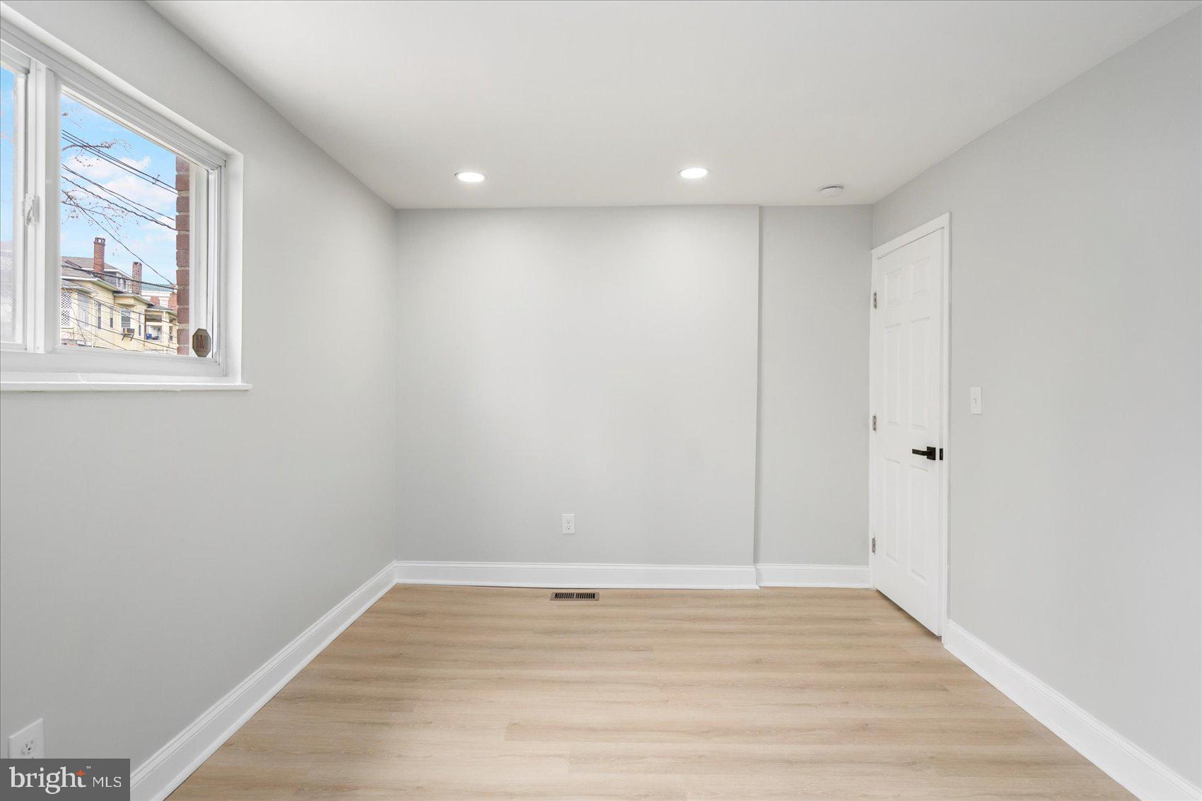 4002 Derby Manor Drive Baltimore, MD 21215 - Photo 17 of 32 a view of room with window and wooden floor