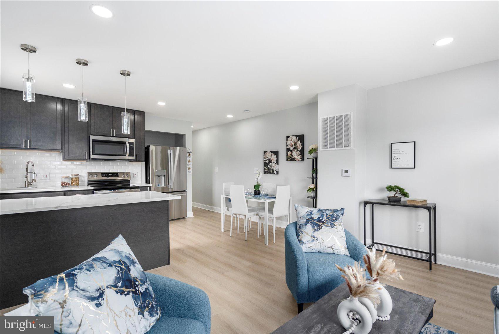 4002 Derby Manor Drive Baltimore, MD 21215 - Photo 7 of 32 a living room with stainless steel appliances furniture and a wooden floor