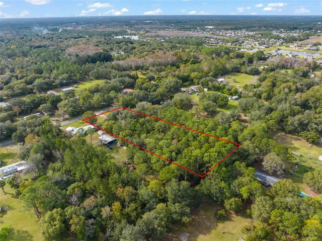 a view of a city with green field