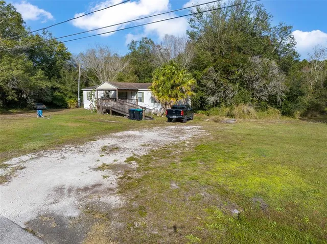 a view of a town with barn house in the background