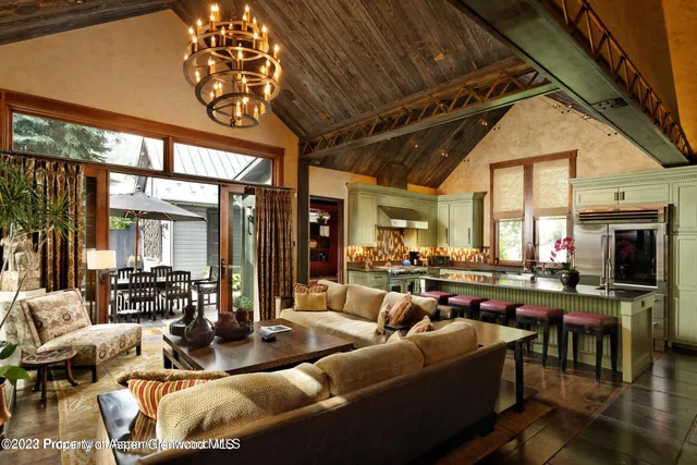 a living room with lots of furniture and a large window